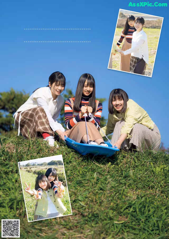 A group of young women sitting on top of a lush green field.