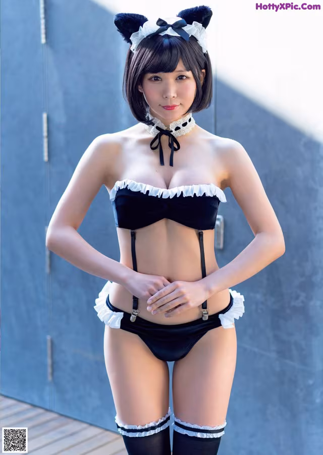A woman in a black and white lingerie posing for a picture.