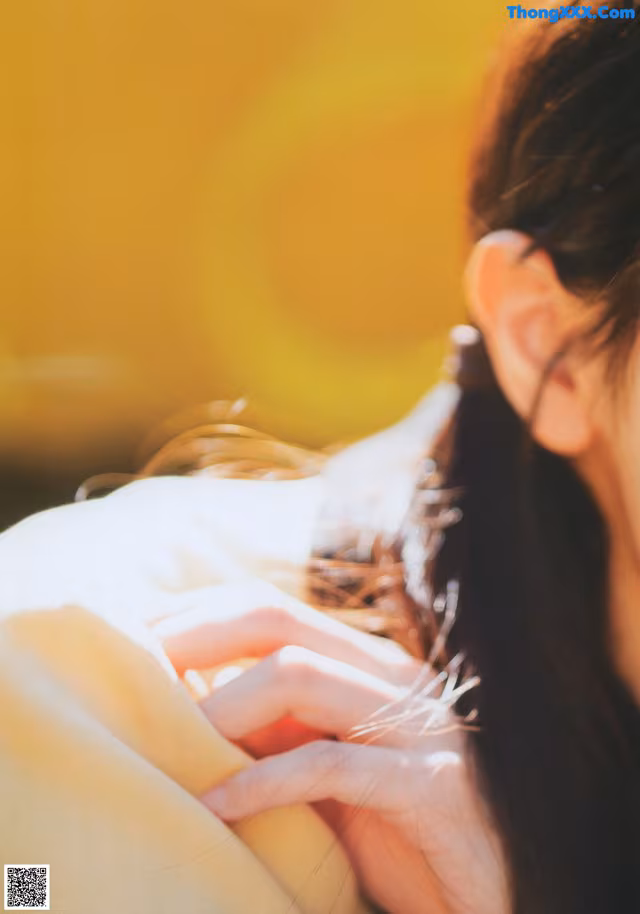 A close up of a woman's hand on her shoulder.