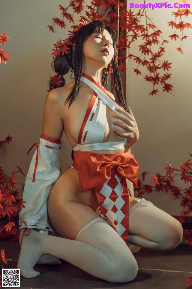 A woman in a red and white outfit is posing for a picture.