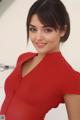 A woman in a red dress posing for a picture.