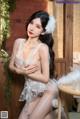a woman in a white lingerie sitting on a chair